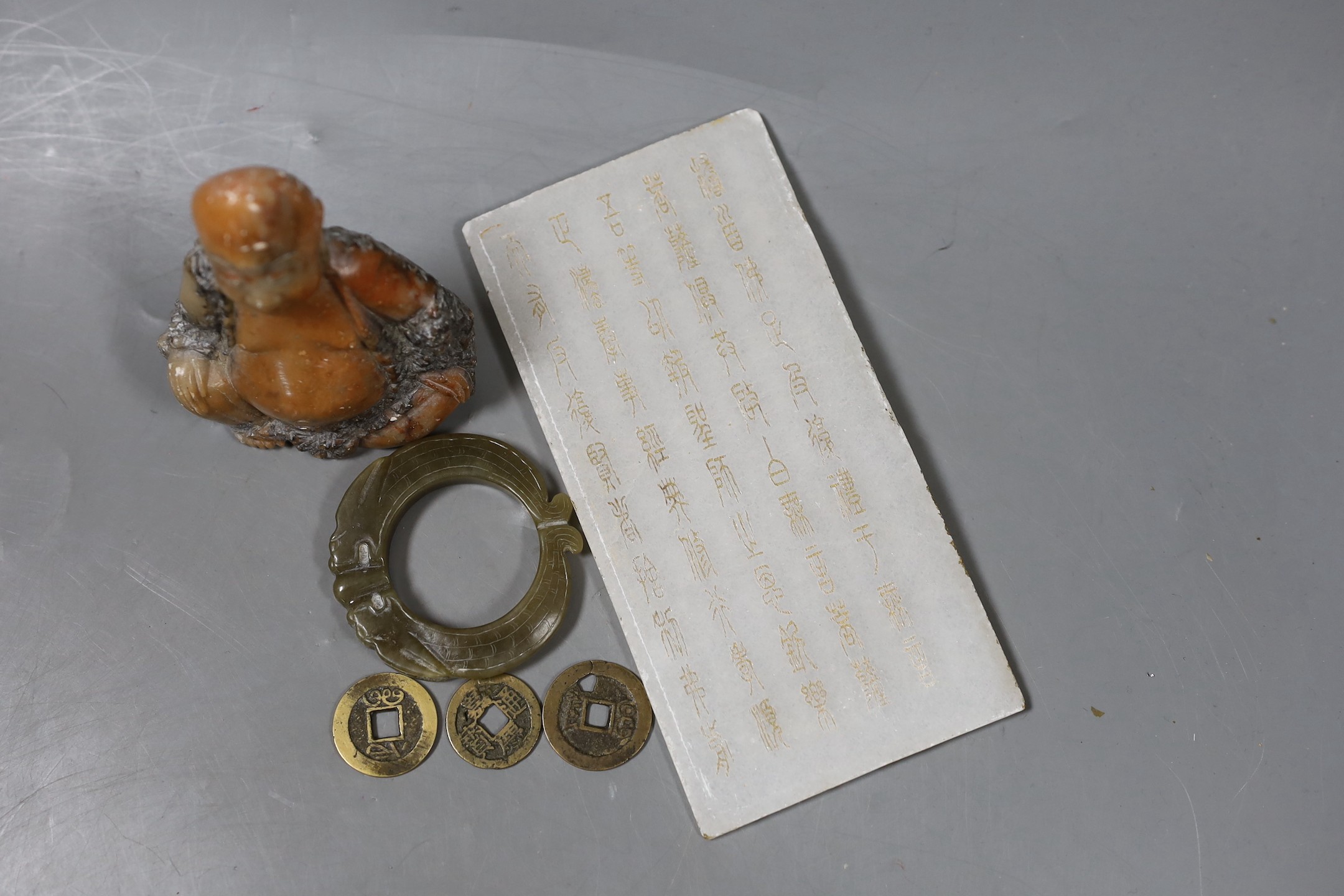 Assorted Chinese items to include a jade ring, coins, a stone inscribed plaque, 15.8 x 8cm and a soapstone figure